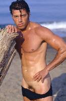 Almost naked man on a beach, very good looking guy.
