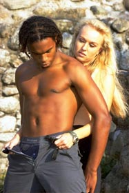 She unzips her lover's pants.